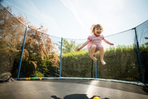 child playing on a trampoline at ahome protected by homeowners insurance